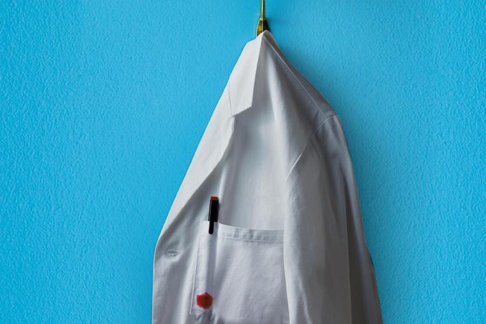 A white doctor's coat on a peg