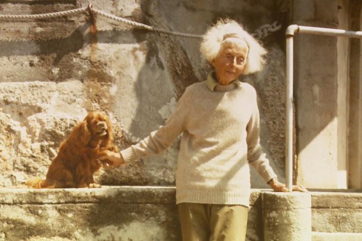 Rowena Cade in the theatre with one of her spaniels